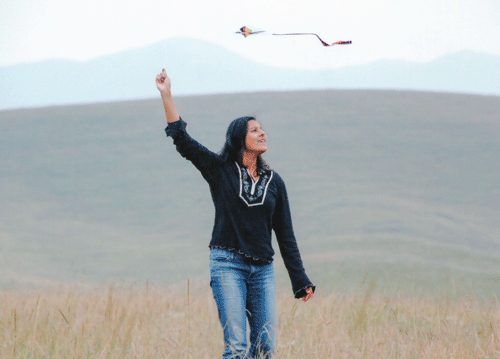 Maya flying a kite near Xiahe, China, on the Silk Road.